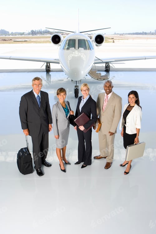 Preview: Elevated View Of The Business Executive Team Standing In Front Of A Private Jet.