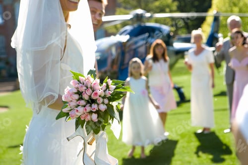 Preview: Selective Focus On Mid Section Of Bride And Groom With Bridesmaids And Guests In The Background