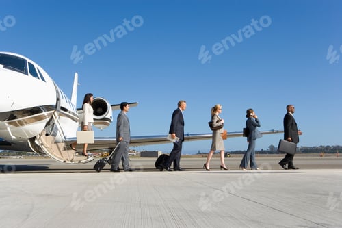 Preview: Close-Up Shot Of A Small Group Of Business Executive Team Alighting From A Private Jet On The