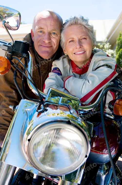 Preview: Close-Up Front View Portrait Of A Senior Couple Sitting On A Motorbike On The Driveway.
