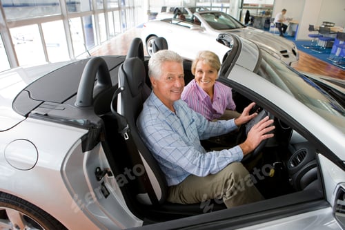 Preview: Couple Looking At The Camera While Checking The Features Of A New Car In The Showroom.