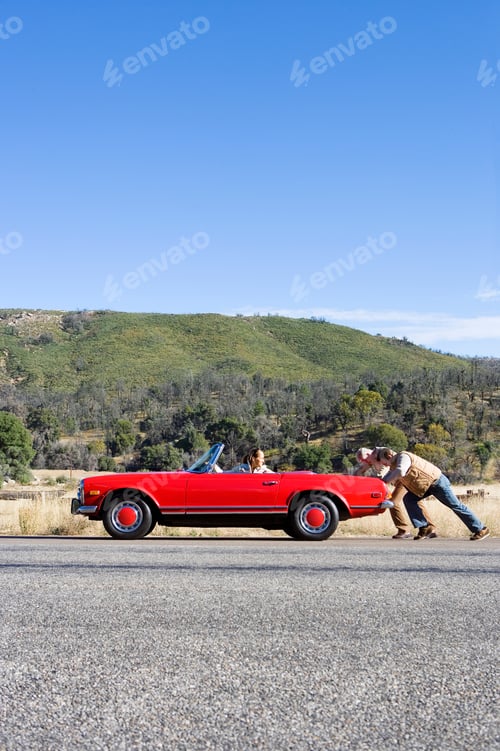 Preview: Vertical Profile Shot Of A Father And Son Pushing A Car Having Trouble With The Daughter At The