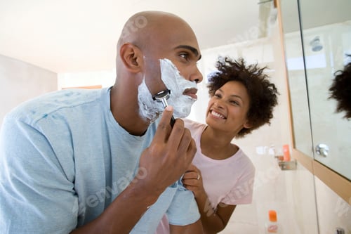 Preview: Close Up Of A Young Man Standing In The Bathroom With Shaving Foam On His Face And Shaving While