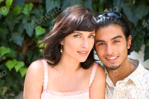 Preview: Close-Up Portrait Of A Young Couple Posing For The Camera On Leafy Camera.
