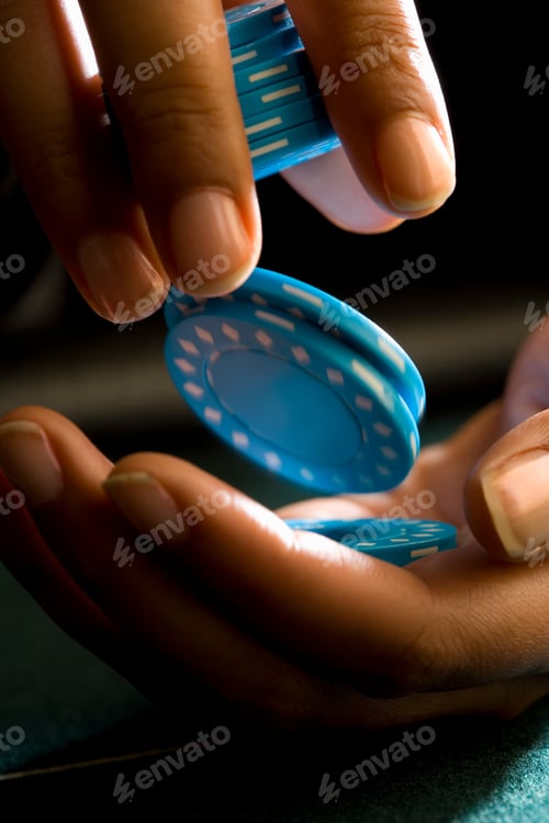 Preview: Vertical Close Up Of A Woman'S Hands Holding And Counting Gambling Chips During A Game Of Poker At