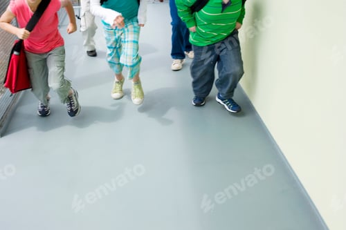 Preview: Horizontal Shot Of Lower Section Of Children Running In A School Corridor.