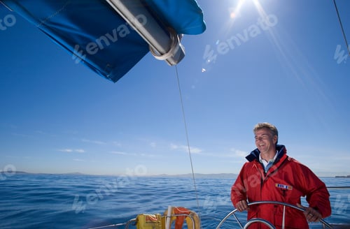 Preview: Mid Shot Of A Man In Red Jacket Standing At The Helm Of Sailing Boat Out At Sea.