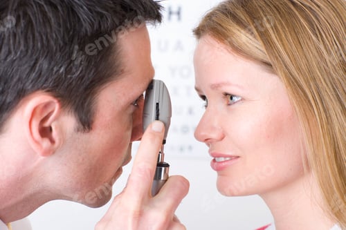 Preview: Close Up Of A Doctor Examining A Blond Woman Patient'S Eyes With An Ophthalmoscope