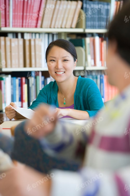 Preview: Portrait Of A Smiling Young Woman Studying In The Library.