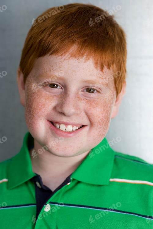 Preview: Vertical Head And Shoulder Portrait Of A Boy In A Green T-Shirt Smiling At The Camera.