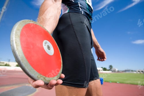 Preview: The Midsection Of A Male Athlete Preparing To Throw The Disk In Discus Throw Competition.