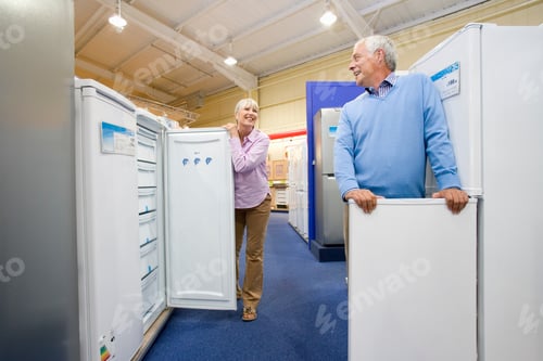 Preview: Senior Couple In An Electronics Appliances Store Checking Out New Refrigerators To Buy In The