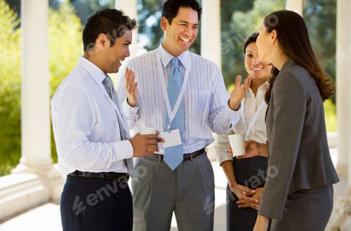 Preview: Horizontal Three Quarter Length Shot Of Four Business Colleagues Chatting During A Coffee Break In