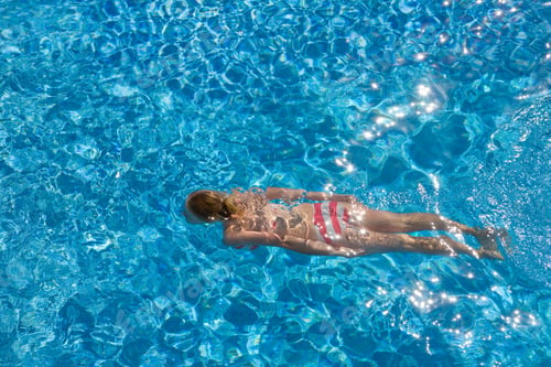 Preview: Girl In A Red And White Bikini Swimming In The Swimming Pool On A Sunny Day.