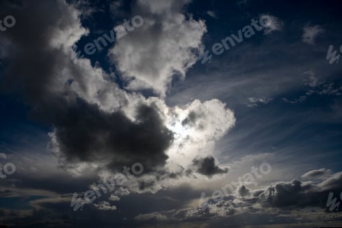Preview: Natural Blue Sky With Fluffy Clouds Hiding The Sun Behind.