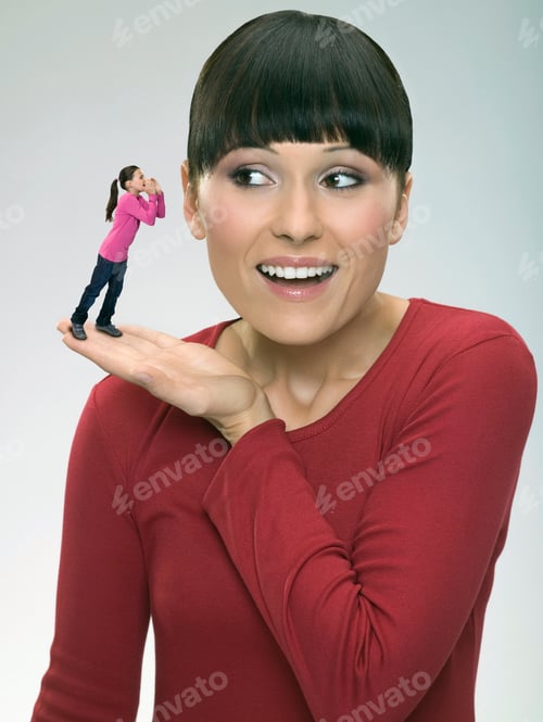 Preview: Young Woman Holding Up Her Daughter Next To Her Ear On Her Palm.