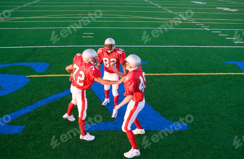 Preview: Elevated Horizontal View Of Two American Football Players Congratulating Teammate On The Pitch