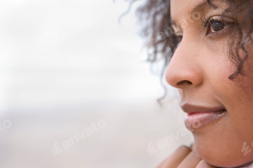 Preview: Close Up Of A Woman Looking Sideways And Smiling On A Bright, Sunny Day At The Beach