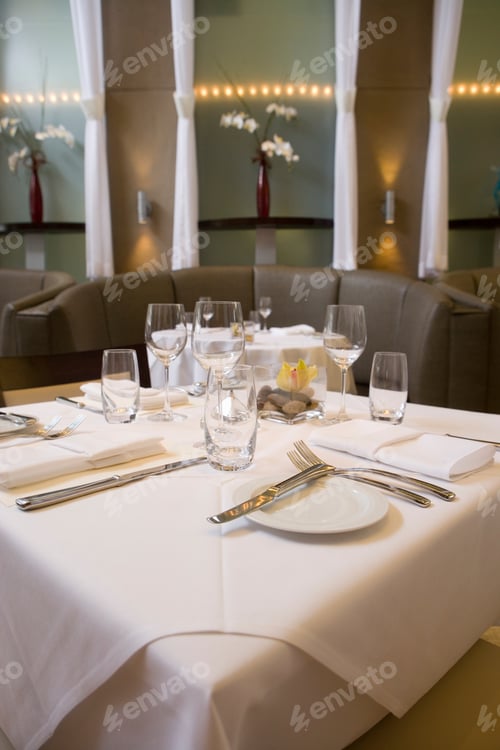 Preview: Vertical Shot Of A Set Table With Glasses And Plates At A Posh Restaurant.