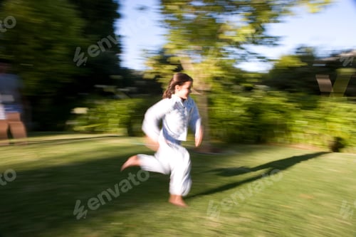Preview: Young Girl In Pajamas Running Outside On The Lawn On A Bright, Sunny Day