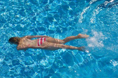 Preview: Girl Wearing A Red And White Bikini Swimming In The Swimming Pool On A Sunny Day.