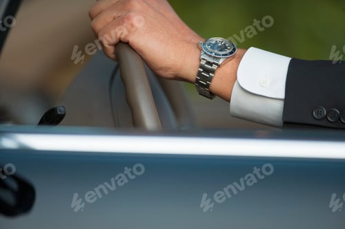 Preview: Horizontal Profile Close Up Shot Of Hand'S Of A Businessman On Steering Wheel Of A Car.