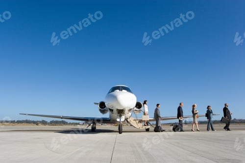 Preview: A Small Group Of Business Executive Team Alighting From A Private Jet On The Runway.