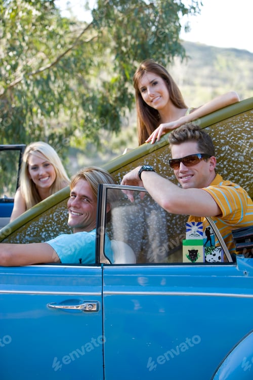 Preview: Portrait Of Four Young Happy Surfers In Car Looking At The Camera.