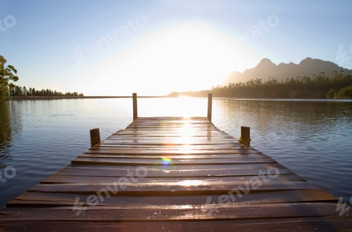 Preview: Horizontal Low Angle Shot Of A Wooden Jetty On A Tranquil Lake At The Sunset.