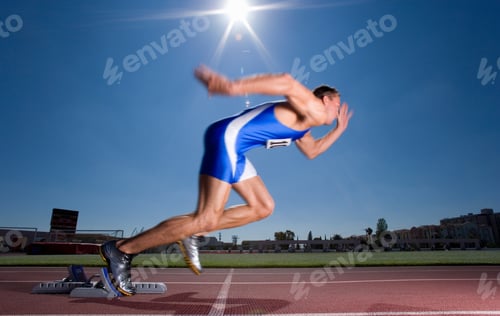 Preview: Young Male Sprinter Setting Off From His Starting Blocks At An Athletics Event On A Bright, Sunny