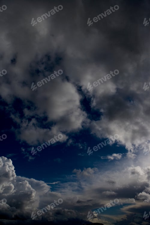 Preview: Natural Blue Sky With Fluffy Clouds Hiding The Sun Behind.
