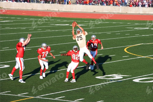 Preview: Football Player Catching Football Professional Football Player Catching Football Mid-Air In A