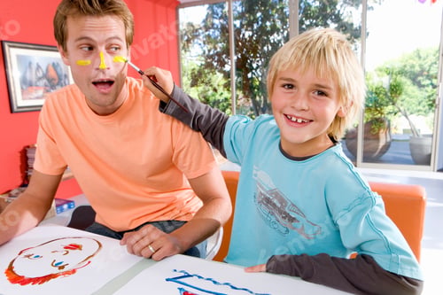 Preview: Little Boy Applying Paint To His Father'S Face Using His Paintbrush While They Are Painting