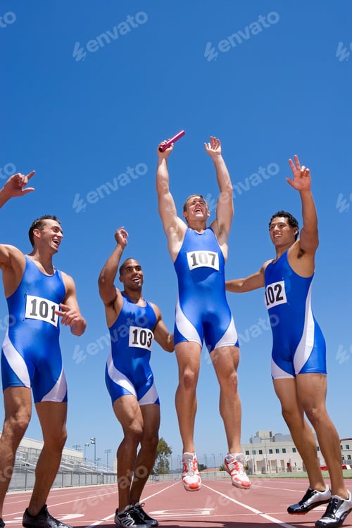 Preview: Young Male Athletes Jumping And Cheering After Winning A Race On A Bright, Sunny Day At An