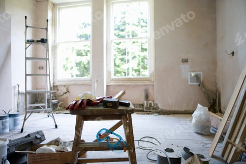 Preview: Wide Shot Of A Windowed Room Under Renovation With Tools Strewn Across.