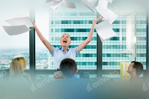 Preview: Horizontal Portrait Of A Businesswoman Throwing Paperwork In Air In Celebration As Her Seated