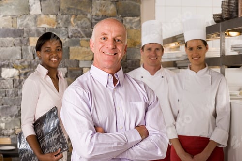 Preview: Close-Up Portrait Of A Proud Restaurant Manager Standing With Waitress And Chefs Near The