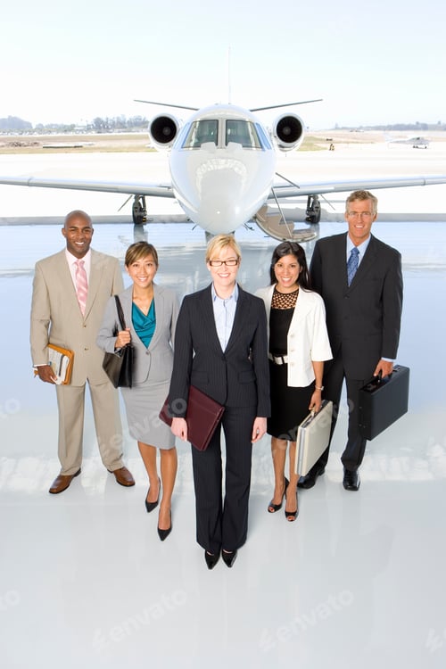 Preview: Vertical Shot Of Executive Business Team Standing In Front Of A Private Jet.