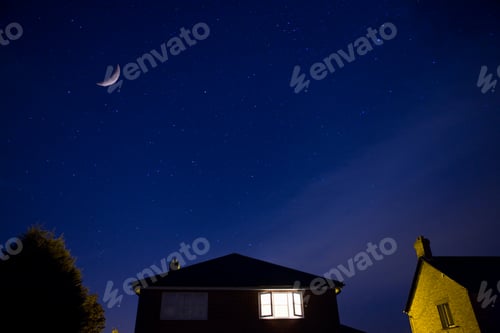 Preview: Horizontal Shot Of A Landscape With House At Night Under Cloudy Sky And Moon.