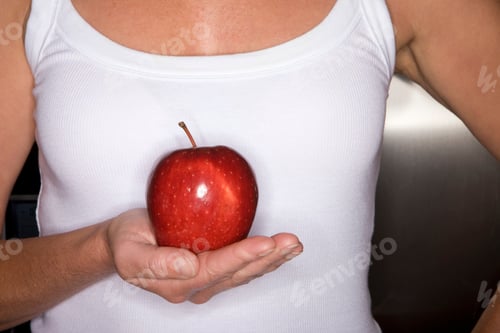Preview: Close Up Of Young Woman Holding Red Apple In Her Palm.