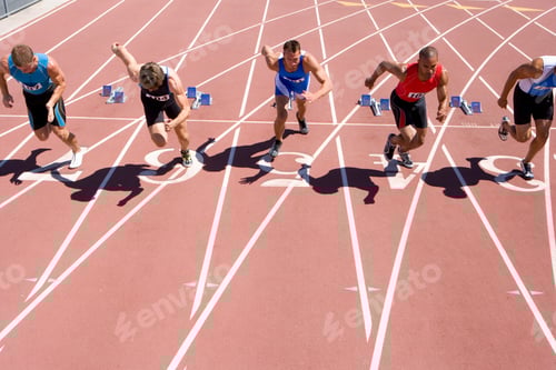 Preview: Front View Of Young Male Sprinters Starting From Their Starting Blocks At The Start Of A Sprint