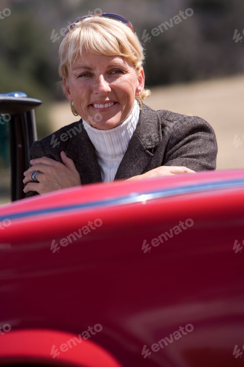 Preview: Vertical Head And Shoulder Shot Of A Senior Woman With Arms Crossed Sitting Inside A Red