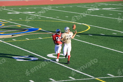 Preview: Wide Shot Of An American Football Player Chasing An Opposing Receiver While Catching The Ball