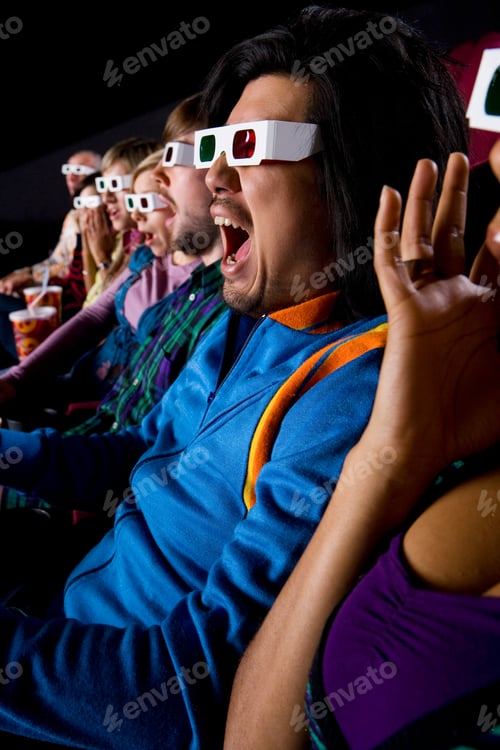 Preview: Vertical Shot Of An Audience In The Cinema Hall Wearing 3D Glasses With Shocked Expression.