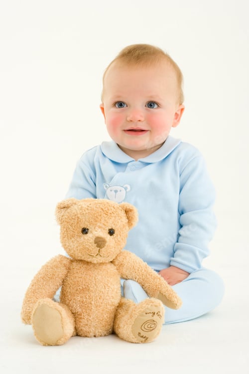 Preview: Vertical Portrait Of A Joyous Seated Baby Boy By The Teddy Bear.