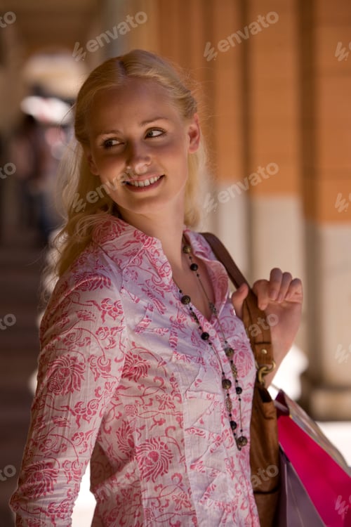 Preview: Close-Up Of A Woman On A Holiday Walking Down A Sunny Corridor Carrying Shopping Bags With Her