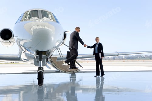 Preview: Businessman Shaking Hands With A Businesswoman While Getting Out Of The Private Jet.