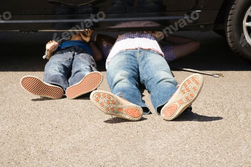 Preview: Father Checking Underneath A Broken Down Car And Trying To Fix It With The Help Of His Little Son