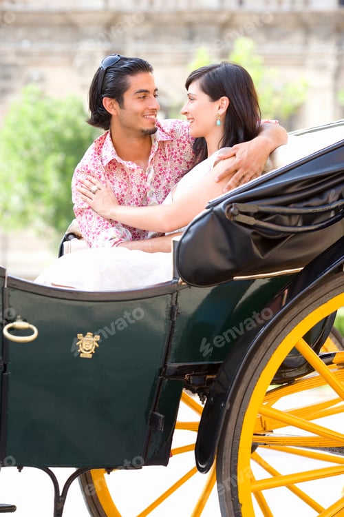 Preview: Vertical Shot Of A Young Couple In Horse-Drawn Carriage Hugging And Smiling At Each Other On A
