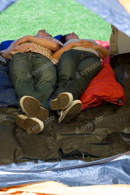 Preview: Vertical Elevated Shot Of A Young Couple Sleeping In Tent On A Garden Lawn Over Sleeping Bags